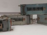 four pieces of old fashioned appliances sitting on a white surface