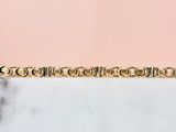 an image of a gold plated bracelet on a marble surface