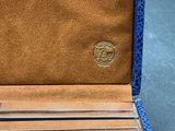leather wallet with a blue lining and a metal clasp