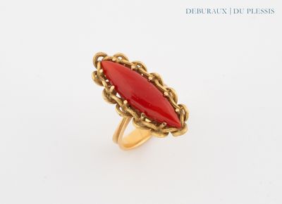 a close up of a ring with a red stone in it