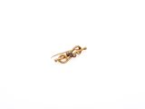 a close up of a gold earring on a white background