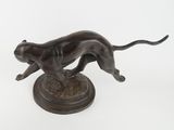 bronze statue of a cat on a pedestal on a white background