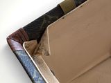 the inside of a louis vuitton wallet with a small piece of paper sticking out of it