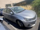 a silver car parked in a parking lot next to other cars