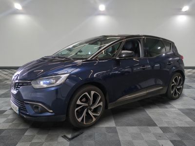 a blue car is parked in a room with a checkered floor