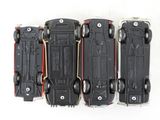 four toy cars that are lined up on a white surface