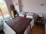 a bedroom with a bed and a desk in it
