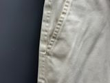 a close up of a person ' s pants with buttons on them