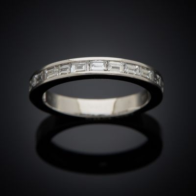 a close up of a diamond ring on a black surface