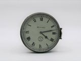 a small clock with roman numerals on the face