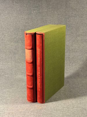 two books are stacked on top of each other on a table