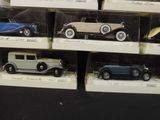 many different model cars on display in a display case