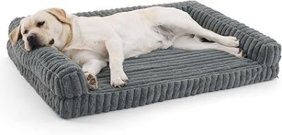 the dog is laying down on the dog bed on the floor