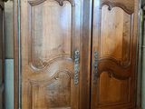 a large wooden cabinet with a door on top of it