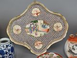 many different types of vases and plates on the table