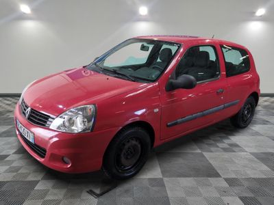 the small red car is parked in the garage on a checkered floor