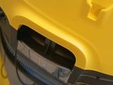the back end of a yellow car with the door open