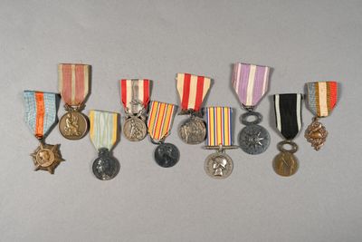 several medals and medals are arranged in a row on a gray surface