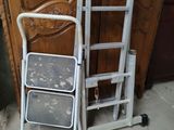 a ladder next to a chair in a room