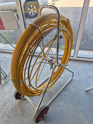 a cart that has a hose on it in front of a window