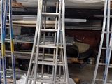 many ladders that are stacked up in a room