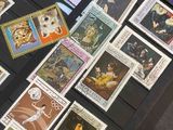 many different stamps on the table and a book on the table