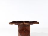 a close up of a small wooden table on a white surface