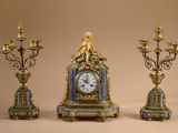 three different types of clocks sitting on a table