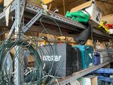 many wires and tools on a shelf in a garage