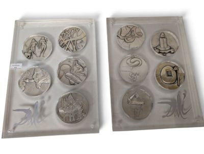 two trays with different types of coins in them