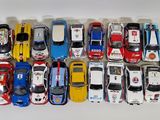 a lot of toy cars that are lined up on a table