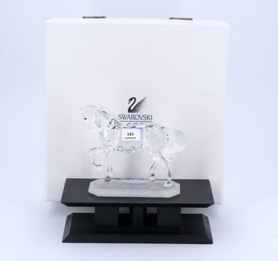 a clear horse figurine on a black base with a white background