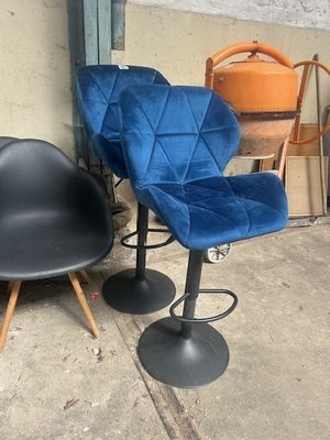 two chairs that are sitting next to each other on the sidewalk