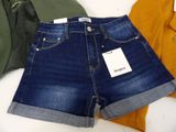 two pairs of denim shorts with tags on them on a white surface