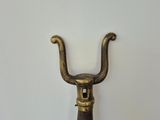 a metal handle with a wooden handle attached to it