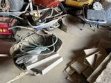 a pile of junk sitting on the floor of a garage
