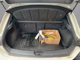 the trunk of a car with a box of wires in it