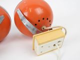 two orange football helmets with silver bands on them