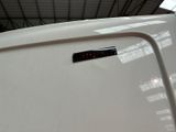 a close up of a white car with a sticker on it