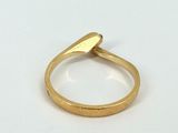 an image of a gold ring on a white surface
