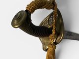 a close up of a sword with a tassel on it