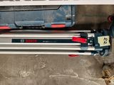 a picture of a tripod and a box of tools on the floor