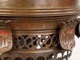 a large bronze vase with a decorative design on it