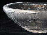 a glass bowl that is sitting on a black surface