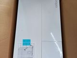 an open cardboard box with a white refrigerator inside of it