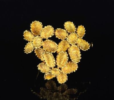 a close up of a bunch of gold flowers on a black surface
