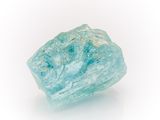a very large piece of blue colored rock on a white surface