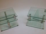 two glass tables that are sitting on a table
