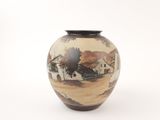 a vase with a painting on it sitting on a table