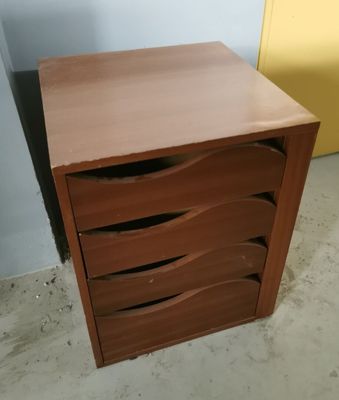 a small wooden cabinet with three drawers in it